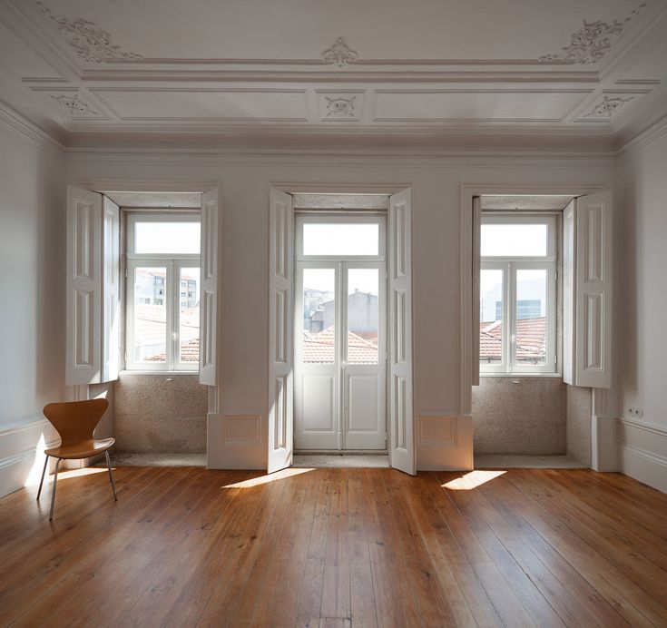 Heritage timber window frames and shutters painted white with ornate ceiling detail, Melbourne renovation